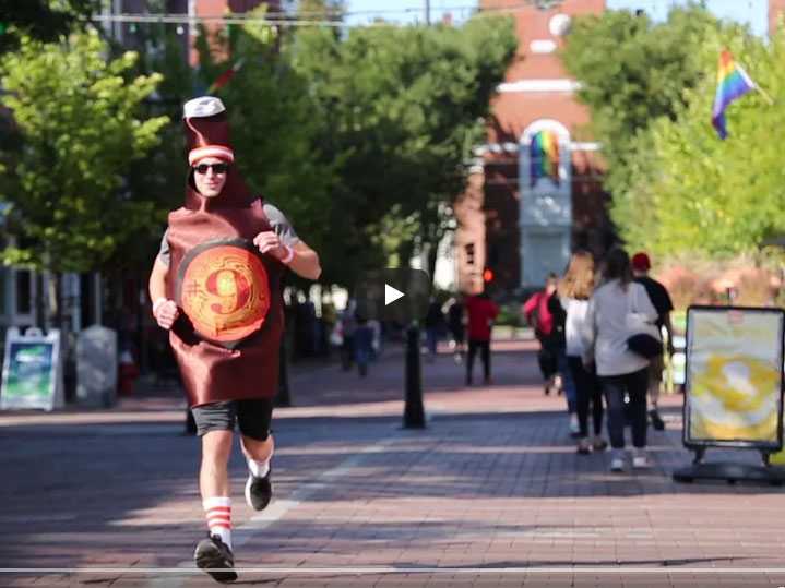 A man dressed as a bottle of Magic Hat #9 and running through Burlington